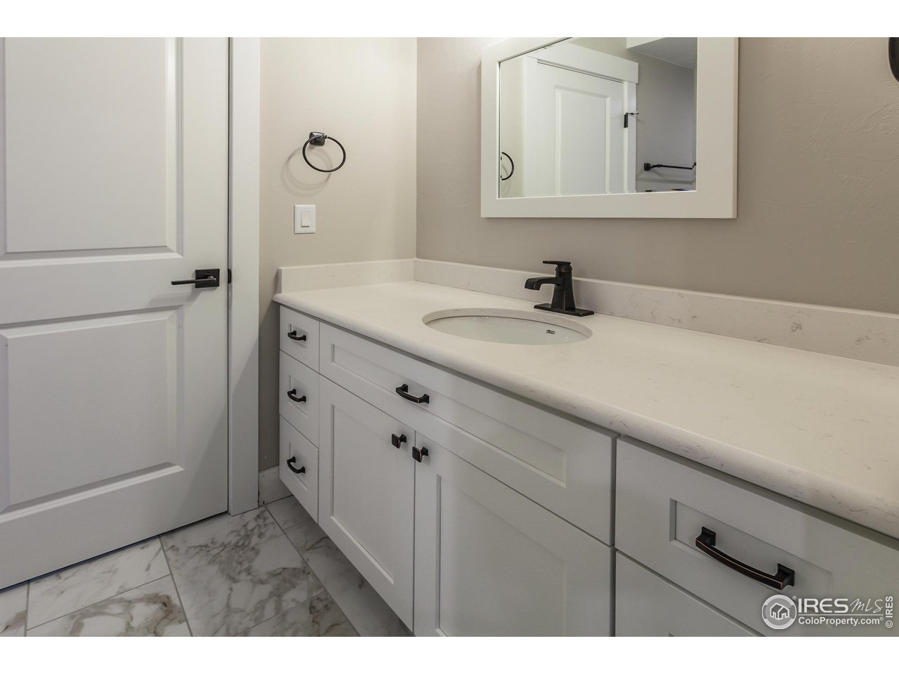 1293 Burt Avenue Berthoud, CO 80513 - Photo 33 of 40 a bathroom with a sink vanity and a mirror