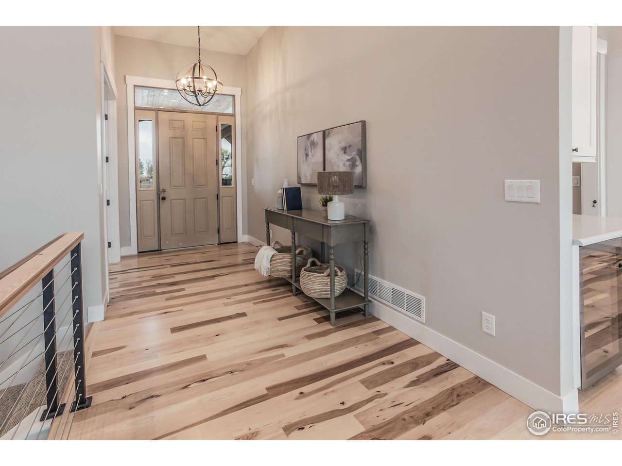 1293 Burt Avenue Berthoud, CO 80513 - Photo 4 of 40 a view of a hallway with wooden floor and a bathroom