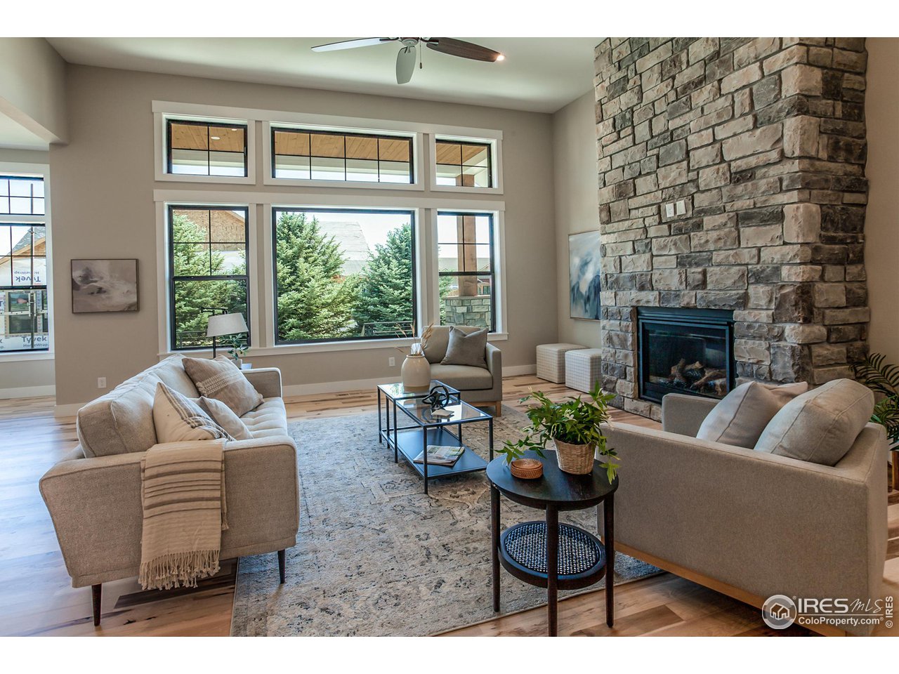 1293 Burt Avenue Berthoud, CO 80513 - Photo 6 of 40 a living room with furniture fireplace and a large window