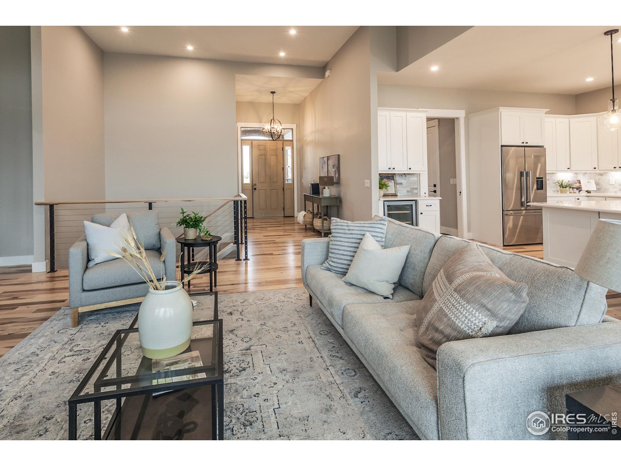 1293 Burt Avenue Berthoud, CO 80513 - Photo 7 of 40 a living room with furniture and a dining table with kitchen view