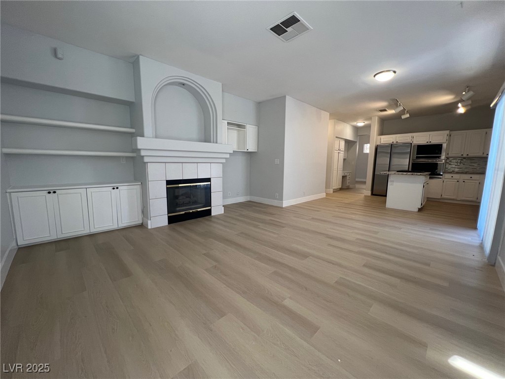 1624 Wandering Winds Way Las Vegas, NV 89128 - Photo 19 of 53 Built-in shelves and a cozy fireplace