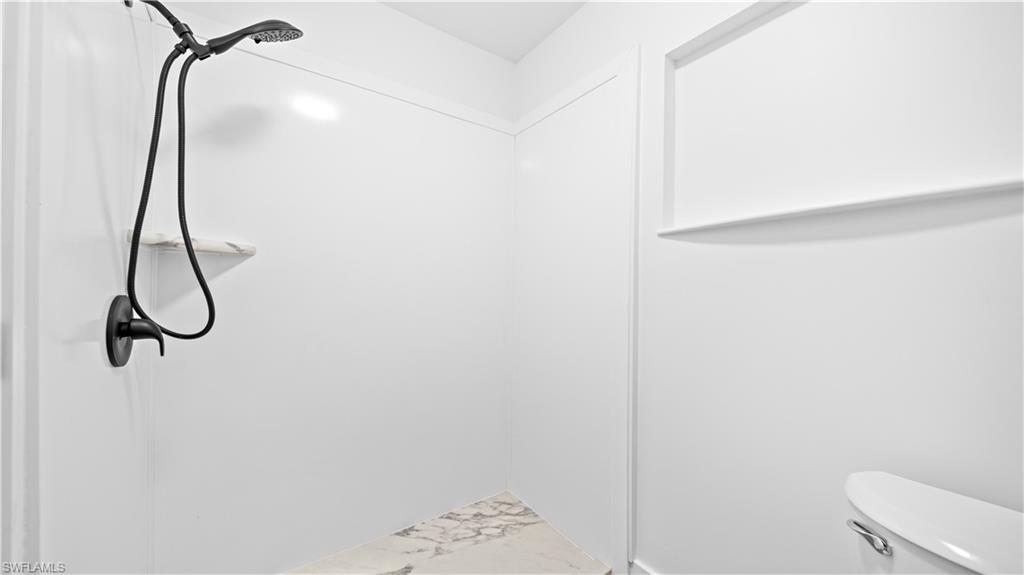 105 Oregon Road North Lehigh Acres, FL 33936 - Photo 11 of 17 Bathroom featuring toilet and marble finish flooring