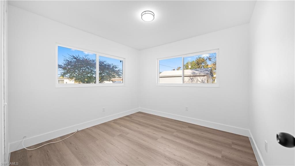 105 Oregon Road North Lehigh Acres, FL 33936 - Photo 12 of 17 Spare room with light wood-style flooring