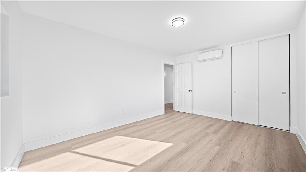 105 Oregon Road North Lehigh Acres, FL 33936 - Photo 13 of 17 Unfurnished bedroom featuring a closet and light wood-type flooring