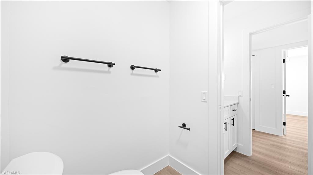 105 Oregon Road North Lehigh Acres, FL 33936 - Photo 8 of 17 Bathroom featuring light wood-type flooring and vanity