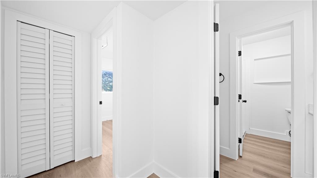 105 Oregon Road North Lehigh Acres, FL 33936 - Photo 9 of 17 Hallway with light wood finished floors