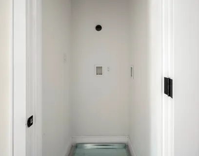 a kitchen with stainless steel appliances granite countertop white cabinets a stove top oven a counter space and a window