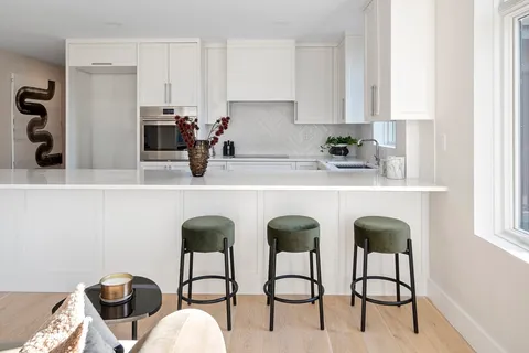 a view of a hallway with wooden shelves