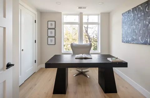 a view of a workspace with a window and dining table
