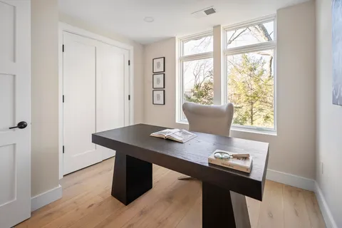 a bedroom with a bed and a large window