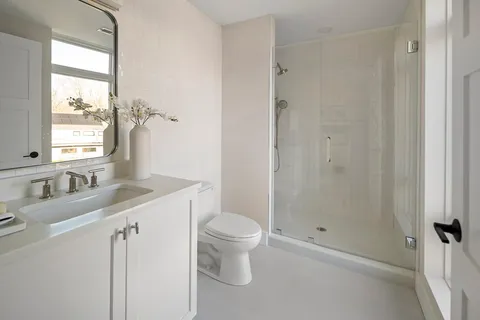 a bathroom with a shower and a toilet