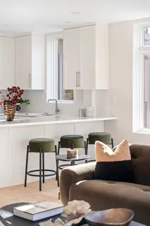 a view of a dining room with furniture a chandelier and wooden floor