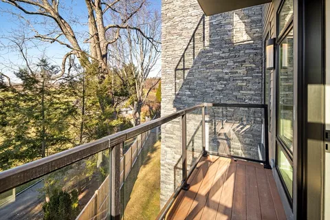 a view of balcony with wooden floor