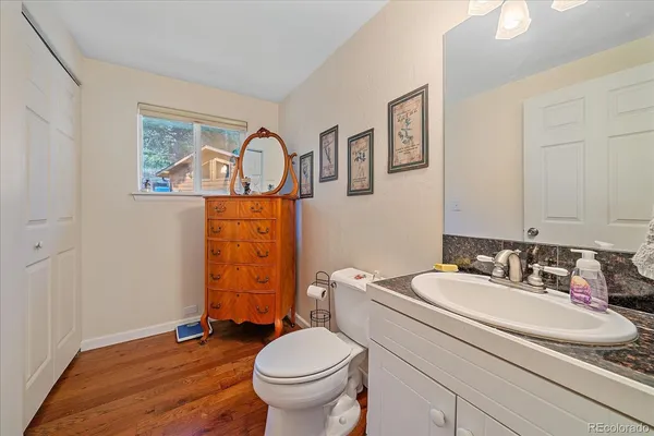 a bathroom with a sink toilet and mirror