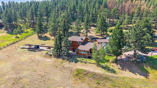 an aerial view of a house with a yard and lake view