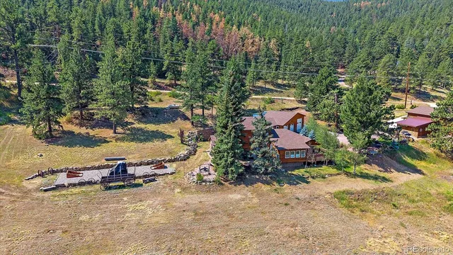 an aerial view of a house with a yard and lake view