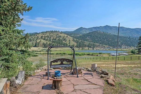 an aerial view of a house with a yard and trees