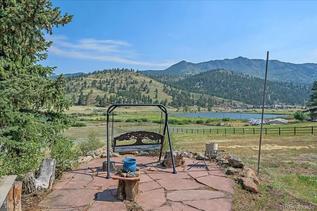 an aerial view of a house with a yard and trees