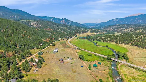 an aerial view of a house with a yard