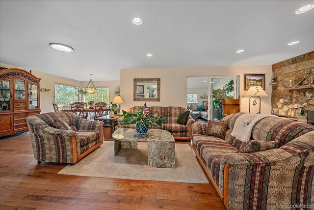 a living room with furniture potted plant and a window