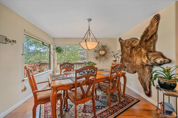 a view of a dining room with furniture a chandelier and wooden floor