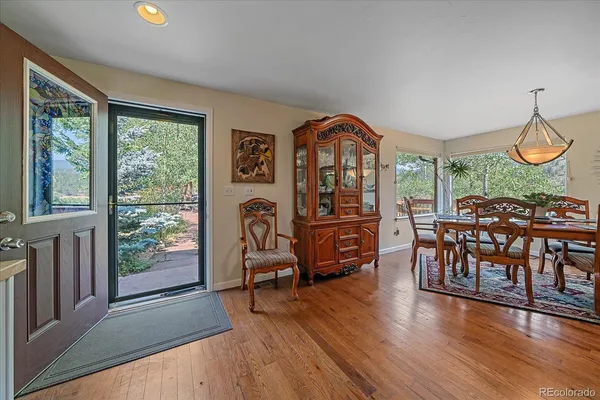 a view of a livingroom with furniture hardwood floor windows and a fireplace