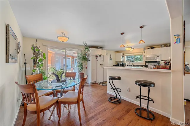 a dining room with furniture and wooden floor