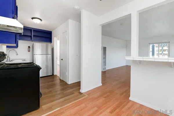 a kitchen with a stove and a refrigerator