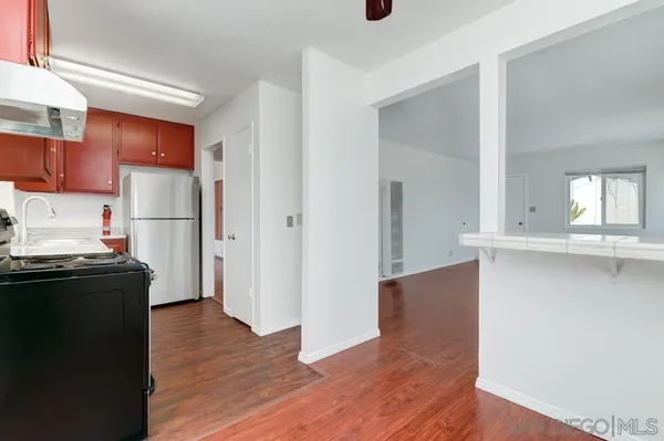 a kitchen with a stove and a refrigerator