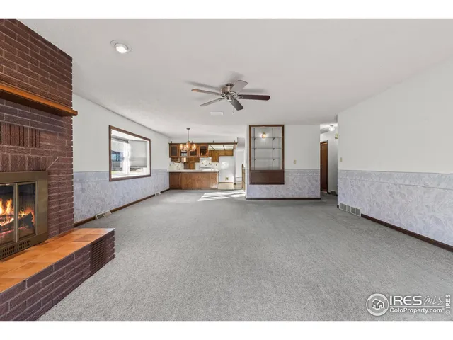 a view of an empty room with a ceiling fan