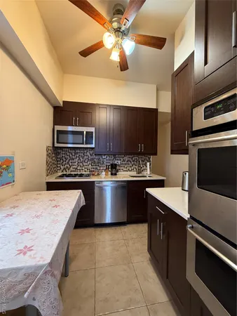 a large kitchen with a stove and a sink