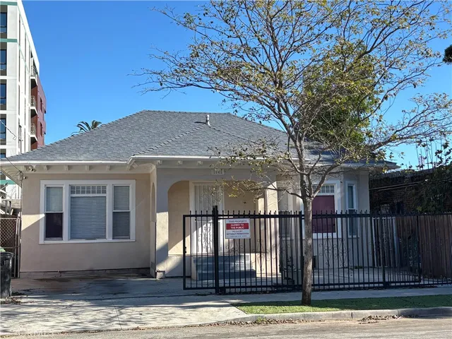 a view of a house with a iron fence