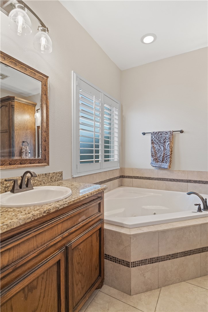 6934 Wooldridge Road, Unit K Corpus Christi, TX 78414 - Photo 15 of 20 a spacious bathroom with a tub sink and mirror