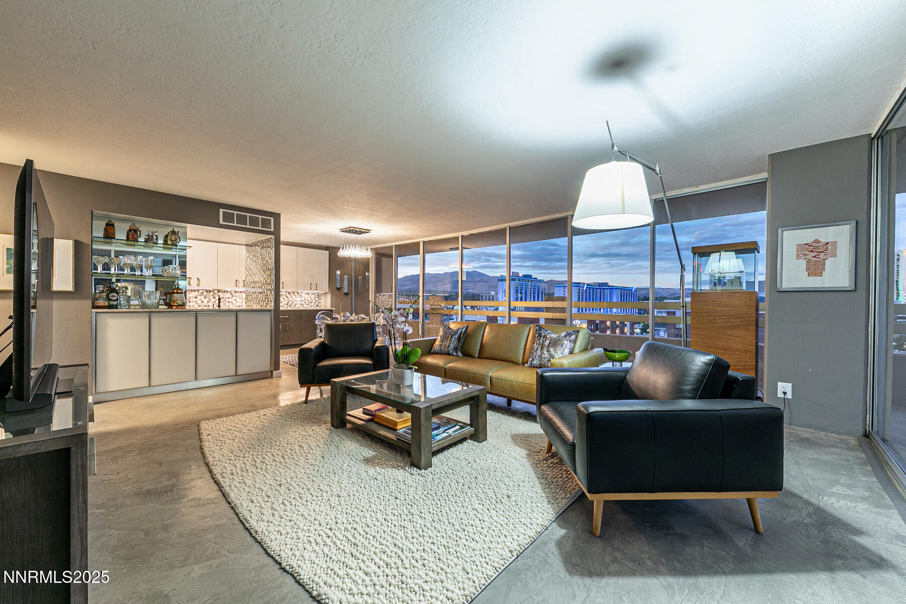 100 North Arlington Avenue, Unit 7K Reno, NV 89501 - Photo 1 of 28 a living room with furniture kitchen view and a wooden floor