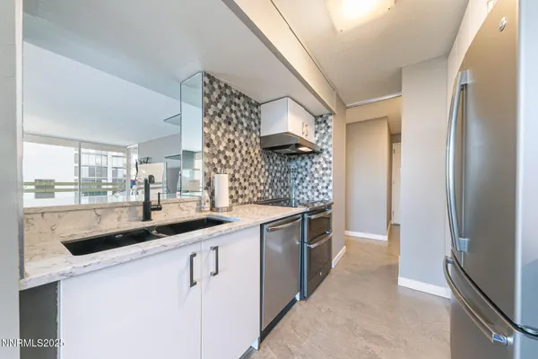 a kitchen with stainless steel appliances granite countertop a sink and cabinets