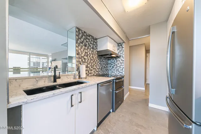 a kitchen with stainless steel appliances granite countertop a sink and cabinets