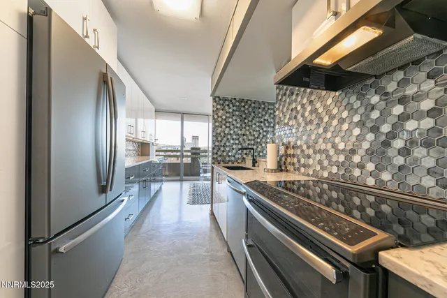 a kitchen with granite countertop a stove and a refrigerator