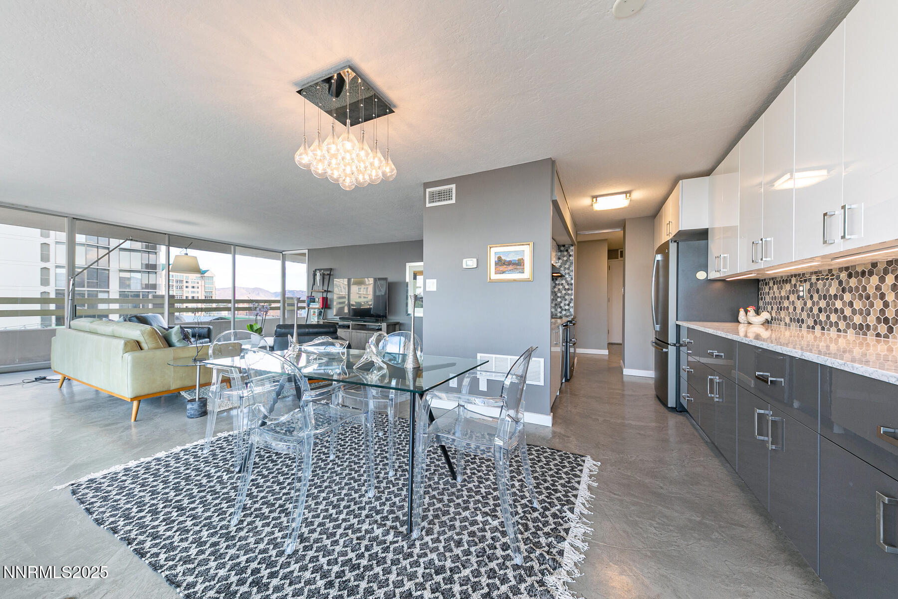 100 North Arlington Avenue, Unit 7K Reno, NV 89501 - Photo 6 of 28 a living room with lots of furniture a rug and white walls