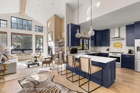 a large kitchen with wooden cabinets and stainless steel appliances