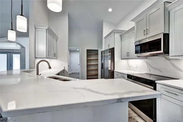 a kitchen with stainless steel appliances a refrigerator and a stove top oven