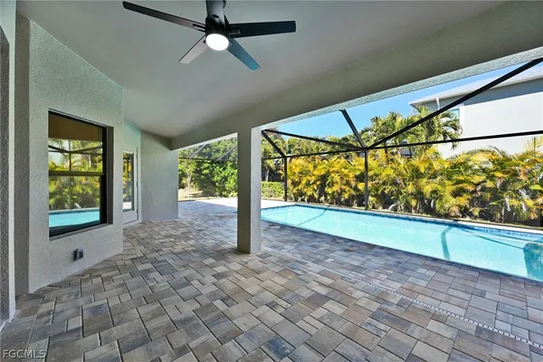 a view of empty room with wooden floor and ceiling fan