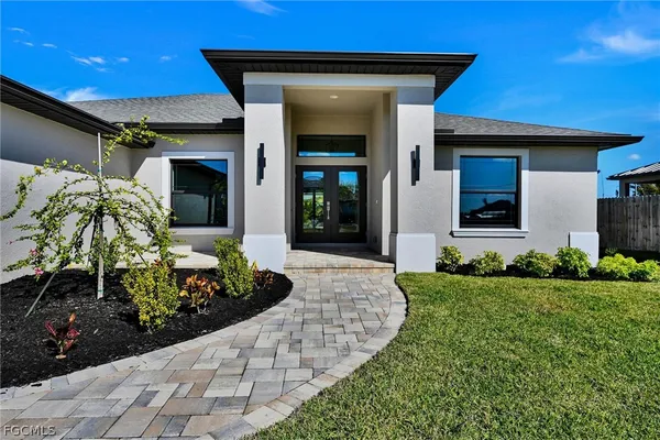 a front view of a house with a yard