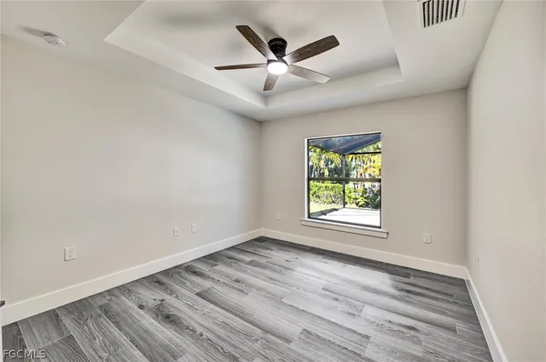 wooden floor in an empty room with a window