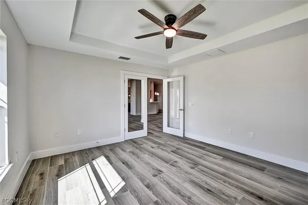 wooden floor in an empty room with a window