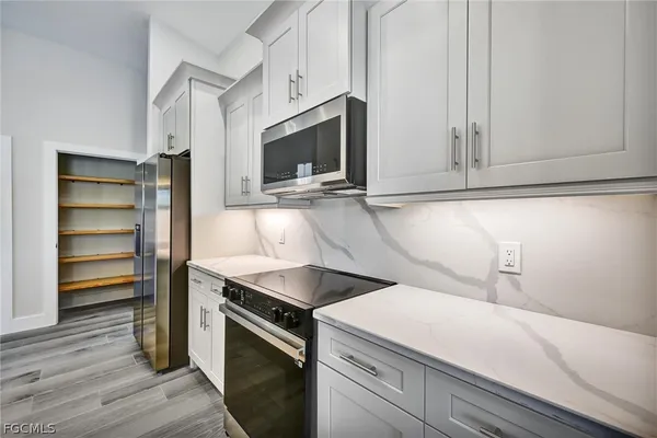 a kitchen with a sink and a microwave