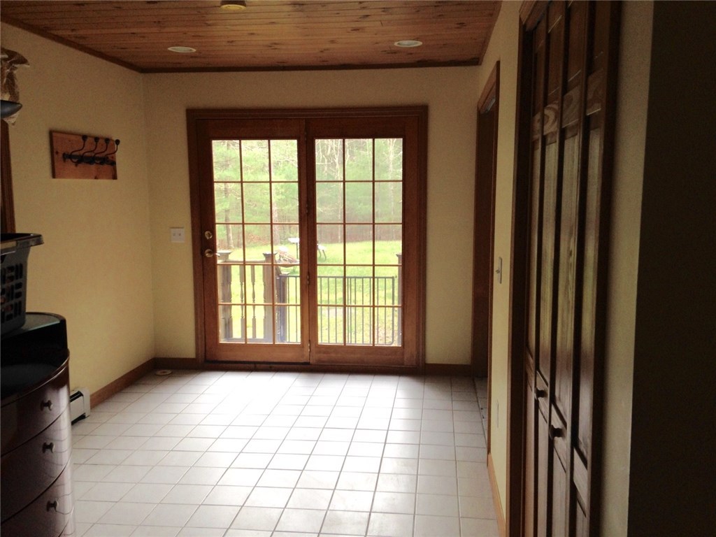 247 Nicholas Road Coventry, RI 02827 - Photo 24 of 34 ONE VIEW OF BONUS ROOM WITH SLIDER AND SMALL DECK ALSO WITH WASHER/DRYER HOOK UP AND LARGE CLOSET FIRST FLOOR/OFF KITCHEN