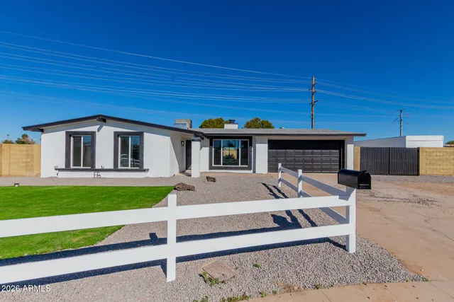 a front view of a house with a garden and porch