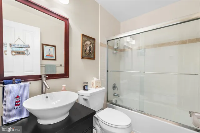 a spacious bedroom with a bed and a cabinets