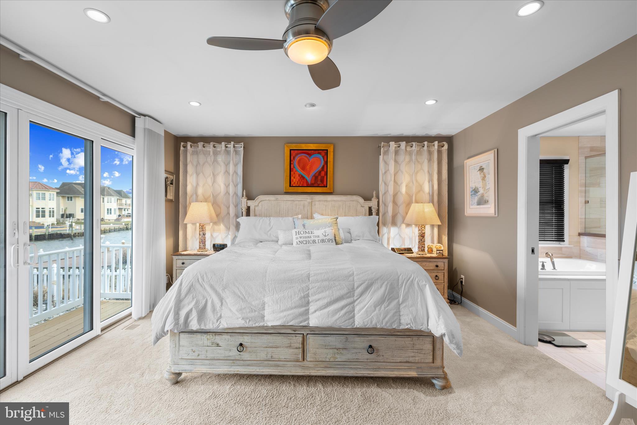 30 Marshall Road Rehoboth Beach, DE 19971 - Photo 30 of 77 a bedroom with a large bed and a chandelier