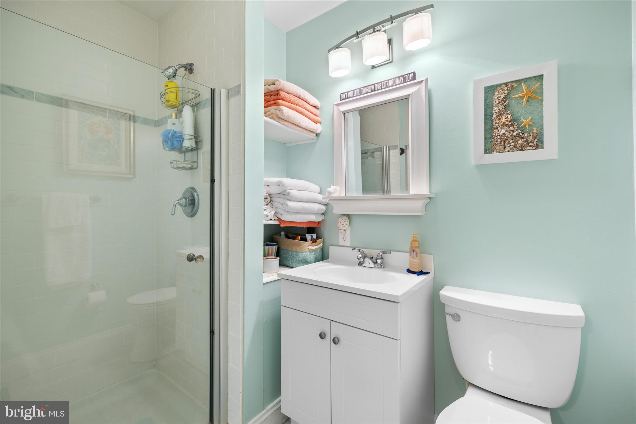 30 Marshall Road Rehoboth Beach, DE 19971 - Photo 35 of 77 a bathroom with a toilet sink and mirror